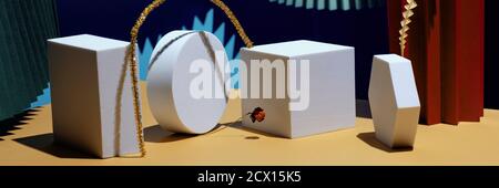 Composition of geometric shapes and colored fans made of cardboard. Concept. Banner Stock Photo
