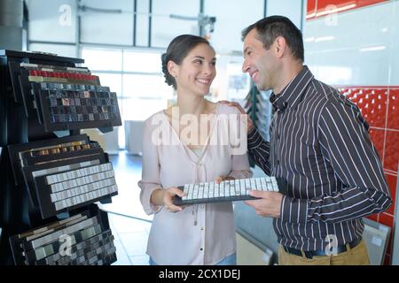 portrait of a couple purchasing mosaic tiles Stock Photo