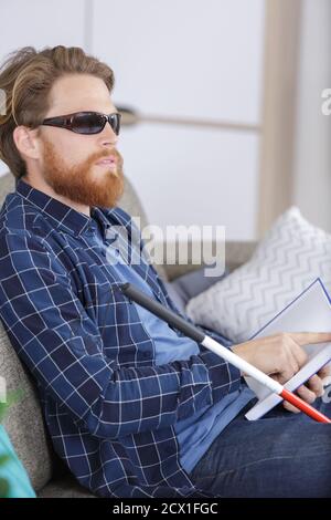 blind man reading braille at home Stock Photo