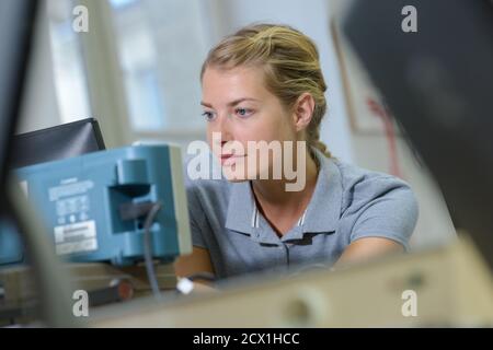 working on an electronic machine Stock Photo