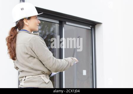 engineer builder woman in uniform holds a paper Stock Photo
