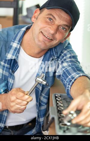 man looking for tools in toolbox Stock Photo