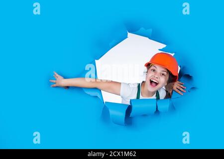 little girl in a helmet. girl making repairs. teen dressed in hard hat. concept of childhood development. girl in helmet is construction worker. foreman teen child. kid work in the helmet. copy space. Stock Photo