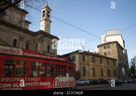 typical traditional tram passes between a street in the center Stock Photo