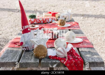Christmas decorations on a picnic table in the countryside after a family snack Stock Photo