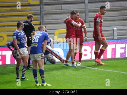 Catalans Dragons' Tom Davies (centre) celebrates his second try of the game with team-mates during the Betfred Super League match at the Emerald Headingley Stadium, Leeds. Stock Photo