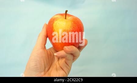 Female hand holds an Apple Stock Photo