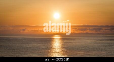 Sunrise on the Irish ocean just off to coast of Ireland Stock Photo