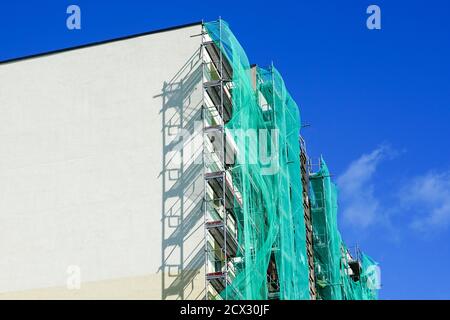 scaffolding arround the house to install thermal insulation of the apartment building facade Stock Photo