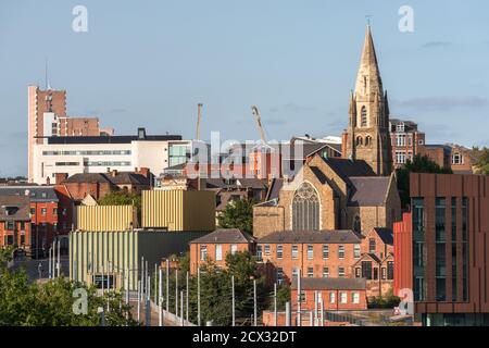 Nottingham, England - November 10, 2020: A modern electric tram pulls into a station in Nottingham City centre, with the famous Lace market district. Stock Photo