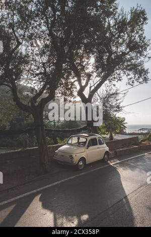 Massa Lubrense, Italy - August 23 2020: Retro, Vintage Fiat Nuova 500 Cinquecento Car in Beige or Ivory parked on the Sorrentine Coast in Summer Stock Photo