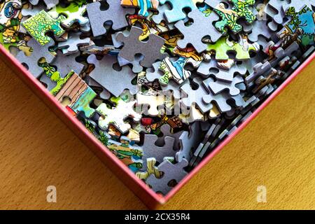 Puzzle pieces in a cardboard box Stock Photo