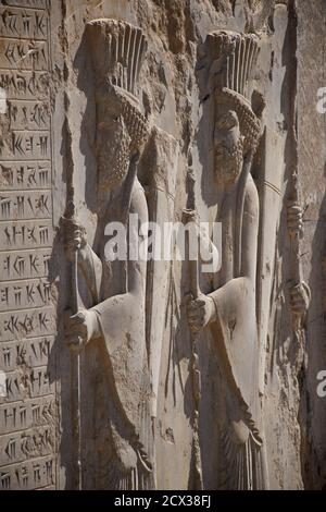 Intricate carving. Palace of Darius the Great, also known as the Tachara, Persepolis, Shiraz, Iran. Persian solidiers Stock Photo