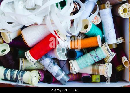 Box with sewing threads disorganized Stock Photo