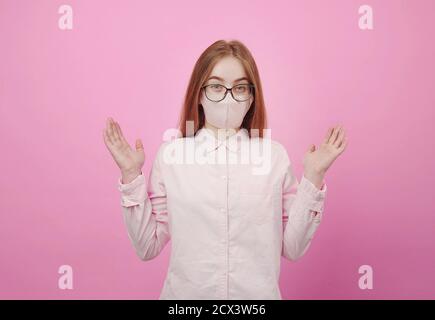 Puzzled young lady wearing facemask Stock Photo