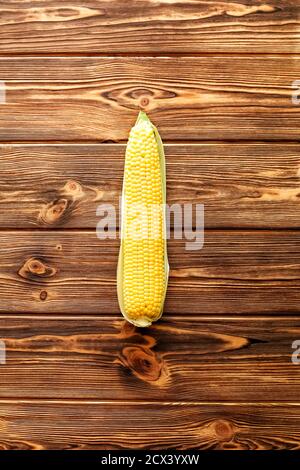 Fresh corn on cob on rustic wooden table. Top view. Stock Photo