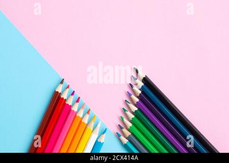 Color pencils on blue and pink background. Stock Photo