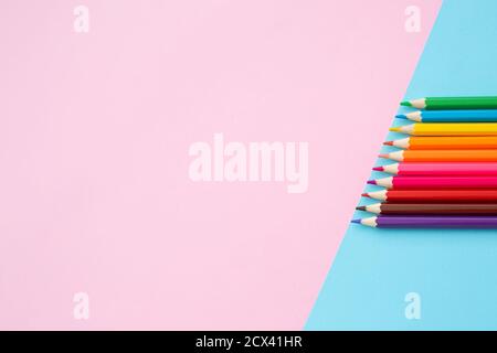 Color pencils on blue and pink background. Stock Photo