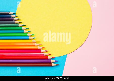 Rainbow bright colored pencils on creative colored background. Stock Photo