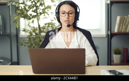 Adult female talking through laptop Stock Photo