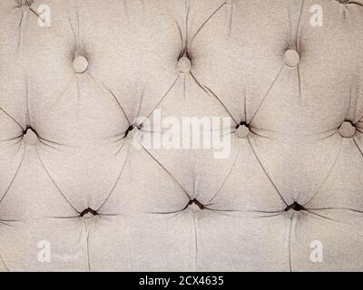 Light fabric quilted backrest with buttons. Full screen photo Stock Photo
