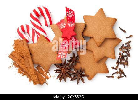 Gingerbreads composition for christmas. Star shape cookies with cinnamon sticks and powder, star anise, dried cloves spice. View from above Stock Photo