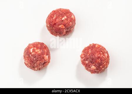 Top view on three raw meatballs on white background Stock Photo