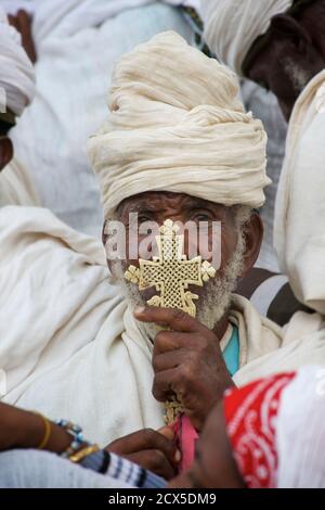 Christian pilgrim with crucifix. Palm Sunday celebratiions, Axum, Tigray, Ethiopia Stock Photo