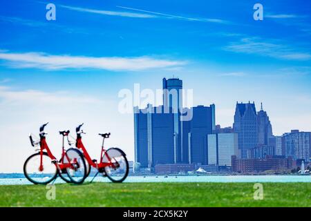 City bicycles on Sunset Point over Detroit river and view of downtown on sunny day from Belle Isle Stock Photo