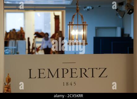 A lamp hangs over the logo of Cologne auction house Lampertz November 4, 2013, who auctioned a German expressionist painting on behalf of Cornelius Gurlitt. The painting from 1930 was auctioned for 720,000 euros in 2011 by Lempertz on behalf of Cornelius Gurlitt, son of art dealer Hildebrand Gurlitt, who was a specialist in the modern art of the early 20th century that the Nazis branded as 'degenerate art'. A vast trove of modern art seized under Germany's Nazi regime was discovered in a Munich apartment belonging to Gurlitt, among stacks of rotting groceries, German magazine Focus reported on