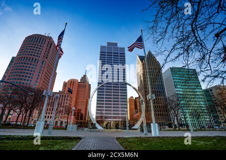 Michigan Labor Legacy Monument on Hart Plaza near river embarkment in Detroit, USA with American flags over city downtown Stock Photo