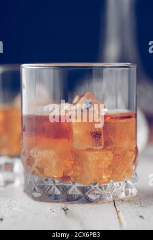 Two glasses of whisky on a wooden bottom. Whiskey Stock Photo