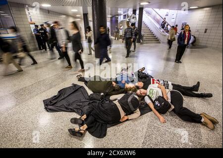 Protesters from the 'The Toronto No Line 9 Network' perform a 'die-in' to demonstrate what they say are the possible effects if the Enbridge operated 'Line 9' petroleum pipeline, which runs under the Finch subway station, ruptured, in Toronto, June 29, 2015. Enbridge has been seeking permission to reverse the flow of the pipeline that runs from southern Ontario to Montreal. The National Energy Board has ordered Enbridge to conduct hydrostatic testing before they can proceed with the plan, according to local media reports.  REUTERS/Mark Blinch
