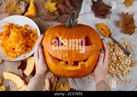 Making scary pumpkin jack for Halloween, holiday preparation Stock Photo