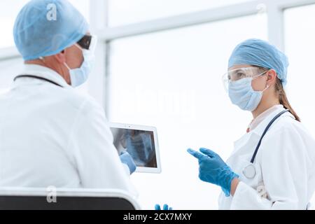 woman doctor looking at the screen of a digital tablet. Stock Photo