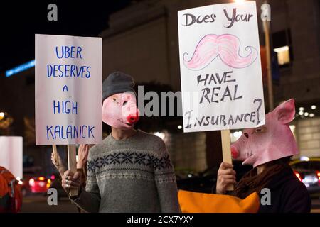 Demonstrators hold signs during a protest organized by the San Francisco Taxi Workers Alliance against ridesharing services Uber and Lyft outside the 8th Annual Crunchies Awards in San Francisco, California February 5, 2015. App-based ride service Uber, and smaller rival Lyft, face separate lawsuits seeking class action status in San Francisco federal court, brought on behalf of drivers who contend they are employees and entitled to reimbursement for expenses, including gas and vehicle maintenance. The drivers currently pay those costs themselves. REUTERS/Stephen Lam (UNITED STATES - Tags: TRA