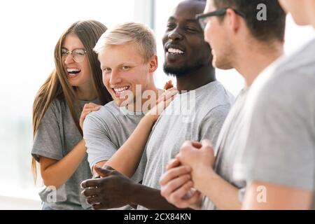 group of happy young people standing in a bright room Stock Photo