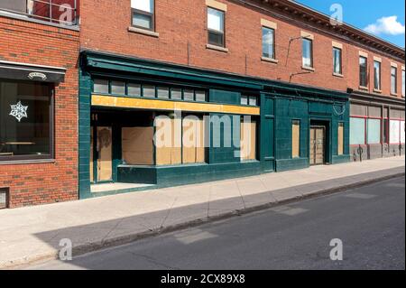 boarded up windows in brick building Stock Photo