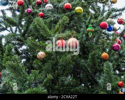 Fragment of an artificial Christmas tree with multi-colored shiny balls Stock Photo
