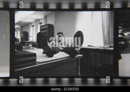 Fine 1970s vintage black and white photography of a funny and friendly guy working a professional job at the office. Stock Photo