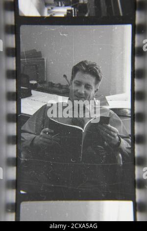 Fine 1970s vintage black and white photography of a funny and friendly guy working a professional job at the office. Stock Photo