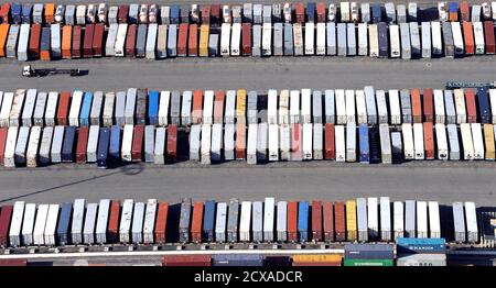 Containers are seen stacked up at the ports of Los Angeles and Long Beach, California February 6, 2015 in this aerial image. The chief labor negotiator for shippers and terminal operators at 29 U.S. West Coast ports raised the ante in contract talks with the dockworkers' union on February 4, 2015, warning that ports plagued by chronic cargo slowdowns were days away from complete gridlock. Picture taken February 6, 2015.   REUTERS/Bob Riha Jr (UNITED STATES  - Tags: TRANSPORT MARITIME BUSINESS EMPLOYMENT)