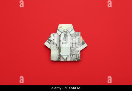 Origami shirt made of dollar banknote on color background Stock Photo