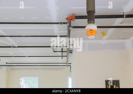 Automatic fire sprinkler system install on pipe ceiling background in office building Stock Photo