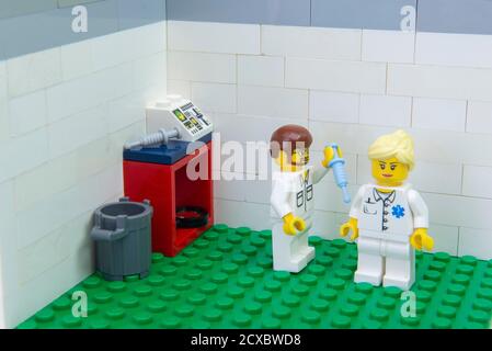 Florianopolis, Brazil. September 19, 2020: Nurse minifigure applying Covid-19 test vaccine to a doctor. Health workers and elderly people belong to th Stock Photo
