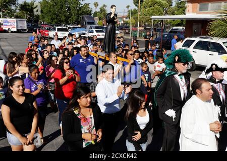 Members of St. Marcellinus parish walk in a procession on the first day of a Southern California tour of the relic of Saint Toribio Romo Gonzalez, the saint of immigrants and border crossers, in Commerce, California July 7, 2014. The relic, an ankle bone from Santo Toribio encased in a small statue, was lent to the Archdiocese of Los Angeles by the saint's home chapel in Jalisco, Mexico. REUTERS/Jonathan Alcorn  (UNITED STATES - Tags: SOCIETY IMMIGRATION POLITICS RELIGION)