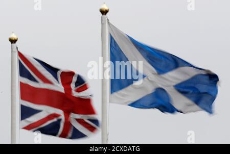 The Union flag and Saltire are seen flying side by side at Bankfoot in Perthshire ,Scotland January 10, 2012. British Prime Minister David Cameron said Scotland should hold an independence referendum as early as next year, clashing with the Scottish National Party (SNP) which wants more time to rally support for a break from the United Kingdom. Cameron, who opposes Scottish independence, said uncertainty about the 300-year-old union between England and its smaller northern neighbour was creating problems for business and harming investment. REUTERS/Russell Cheyne (BRITAIN - Tags: POLITICS SOCI