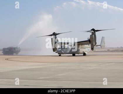 A U.S. Marine Corps MV-22B Osprey with Marine Medium Tiltrotor Squadron 163, Marine Aircraft Group 16, 3rd Marine Aircraft Wing, is drenched during Lieutenant Col. Andrew Norris’, commanding officer of VMM-163, MAG-16, 3rd MAW, last flight at Marine Corps Air Station Miramar, Calif., Sept. 29, 2020. The last flight is a significant event for every pilot and is celebrated by drenching the pilot and helicopter with water. (U.S. Marine Corps photo by Lance Cpl. Juan Anaya)