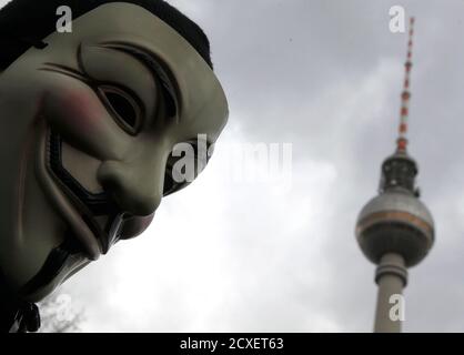A protestor wearing Guy Fawkes masks participates in a demonstration next to the television tower against the Anti-Counterfeiting Trade Agreement (ACTA) in Berlin February 25, 2012. Protesters fear that ACTA, which aims to cut trademark theft and other online piracy, will curtail freedom of expression, curb their freedom to download movies and music for free and encourage Internet surveillance. REUTERS/Tobias Schwarz (GERMANY - Tags: POLITICS CIVIL UNREST)