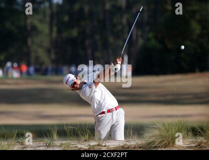 Hideki Matsuyama of Japan hits from the edge of the rough on the 16th hole during the second round of the U.S. Open Championship golf tournament in Pinehurst, North Carolina, June 13, 2014. REUTERS/Mike Segar (UNITED STATES  - Tags: SPORT GOLF)